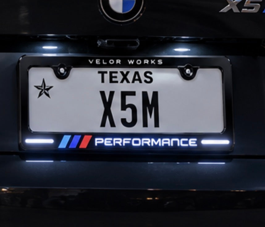 Illuminated license plate frame Design B on a black BMW X5 M at night